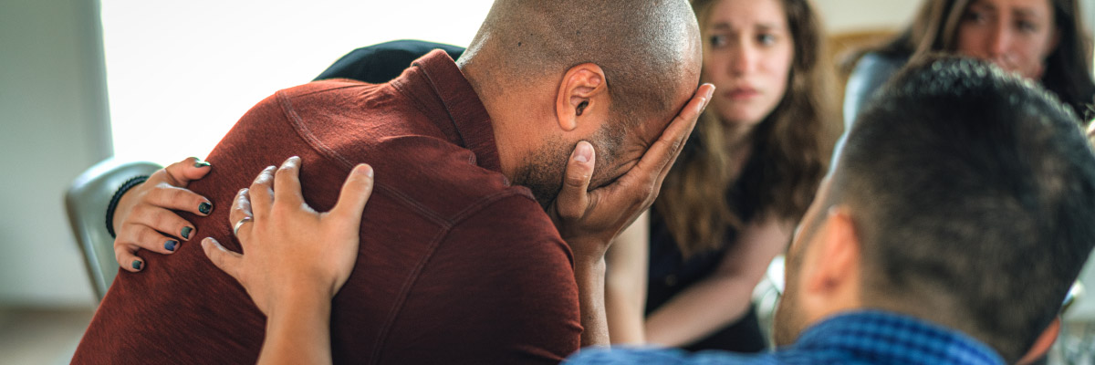 People listening in group therapy