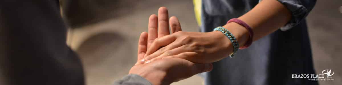 A guy holding the hand of a girl