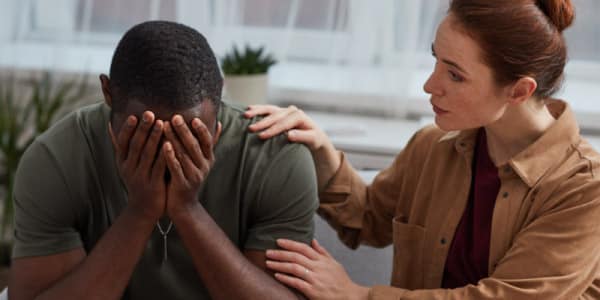Woman comforting a crying man