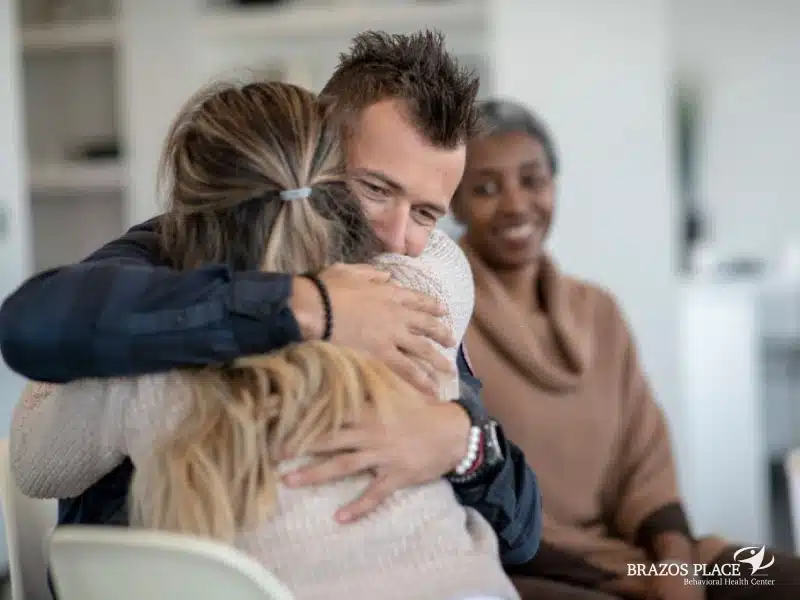 A guy hugging a girl