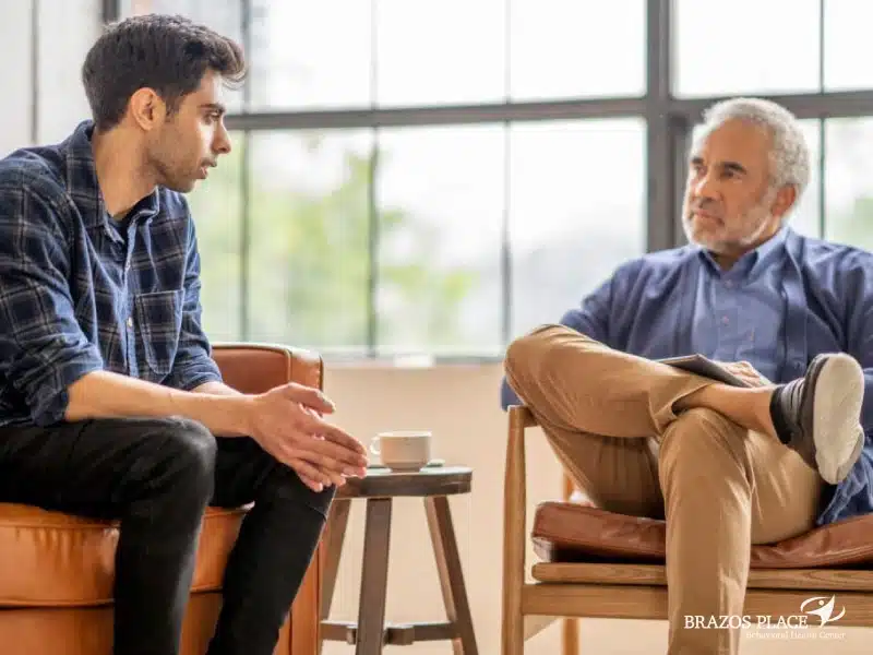 A young and an old man talking to each other